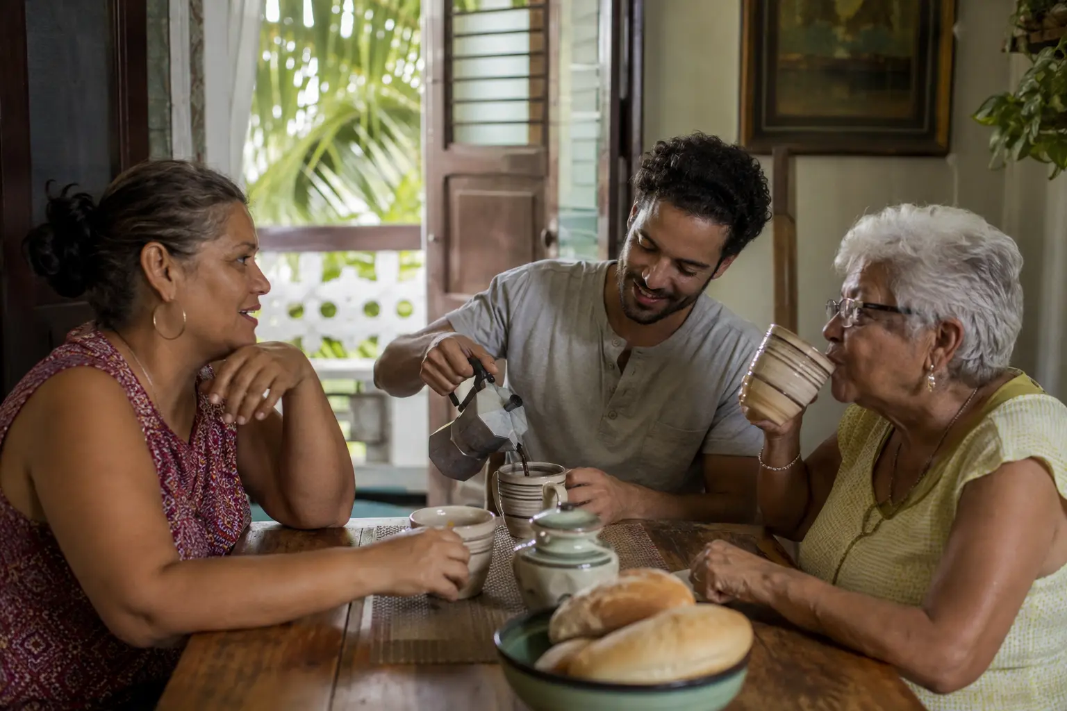 Three generations sharing morning coffee at home